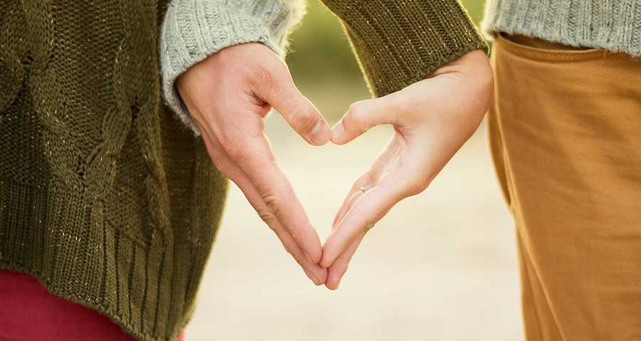 Couple creating a heart with their hands