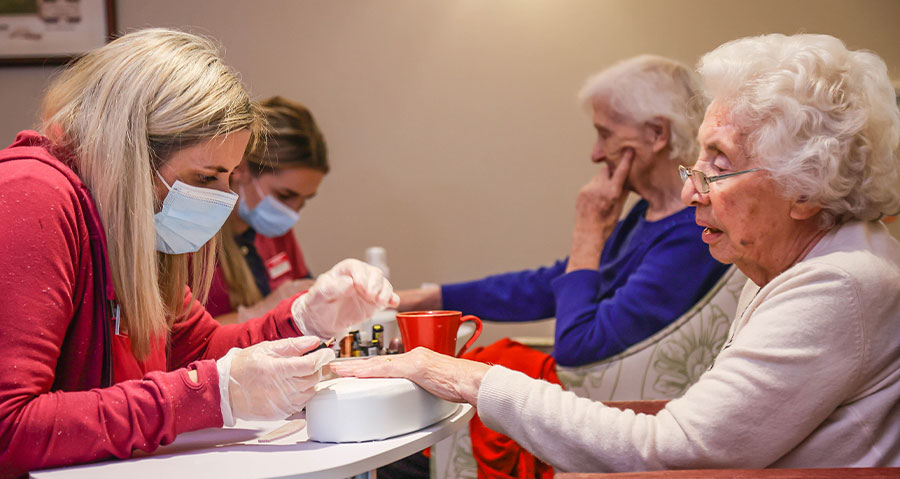 Encore residents receiving a manicure