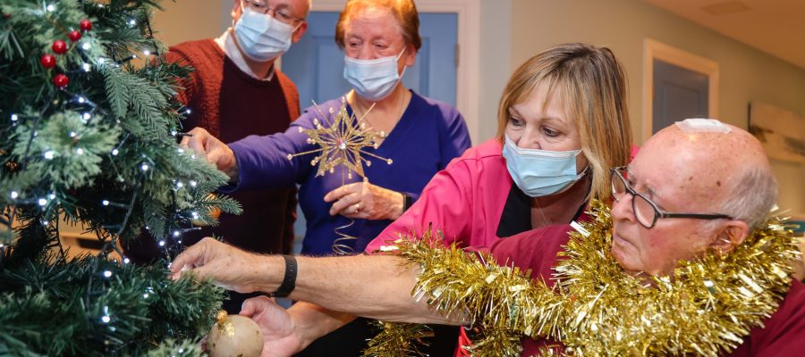 Residents, relatives and staff help to put up the Christmas decorations at Encore Care Homes Fairmile Grange.