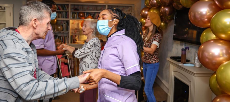 Hamble Heights care home resident dancing with carer